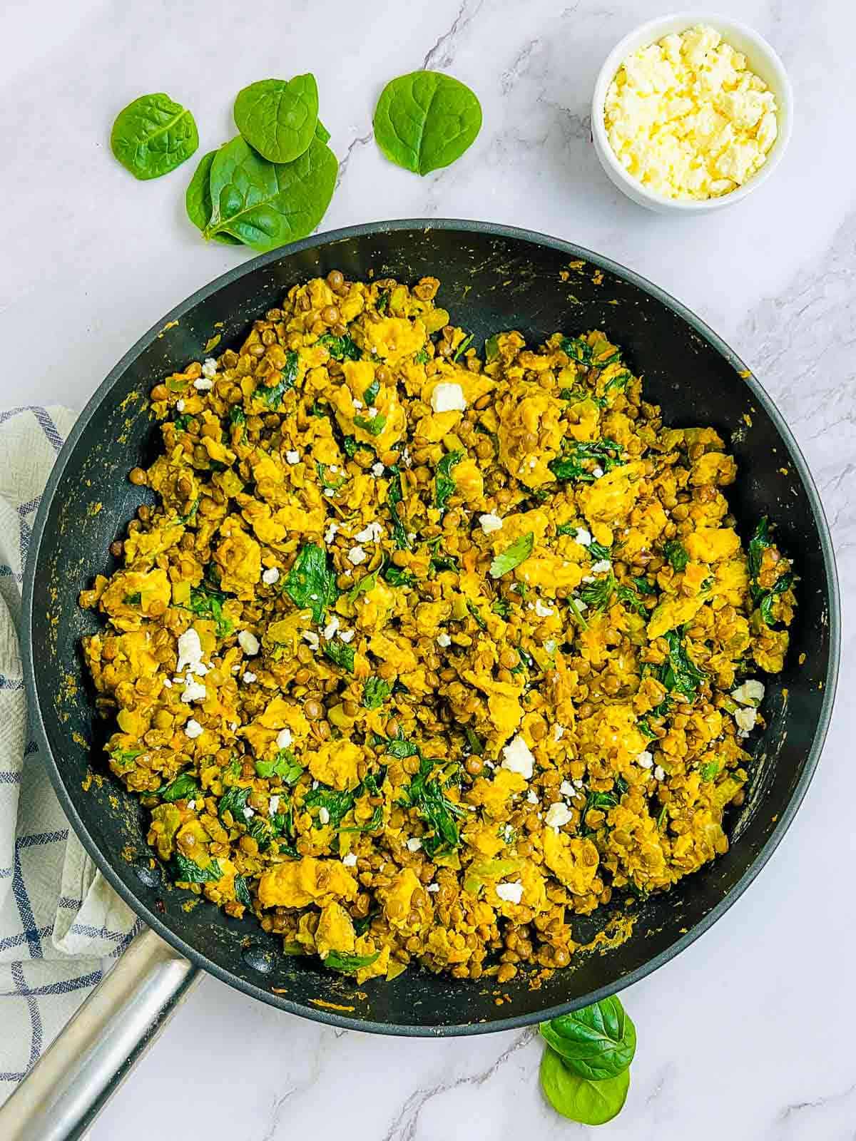 Lentil eggs breakfast scramble in a skillet.