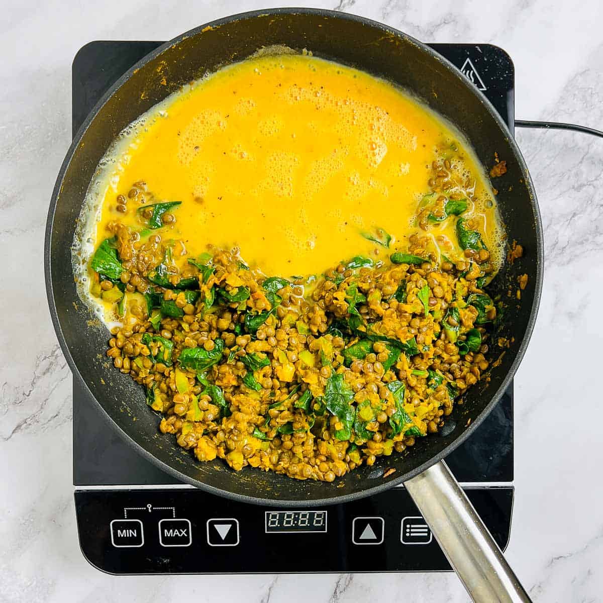 Beaten eggs in the skillet to make the scramble.