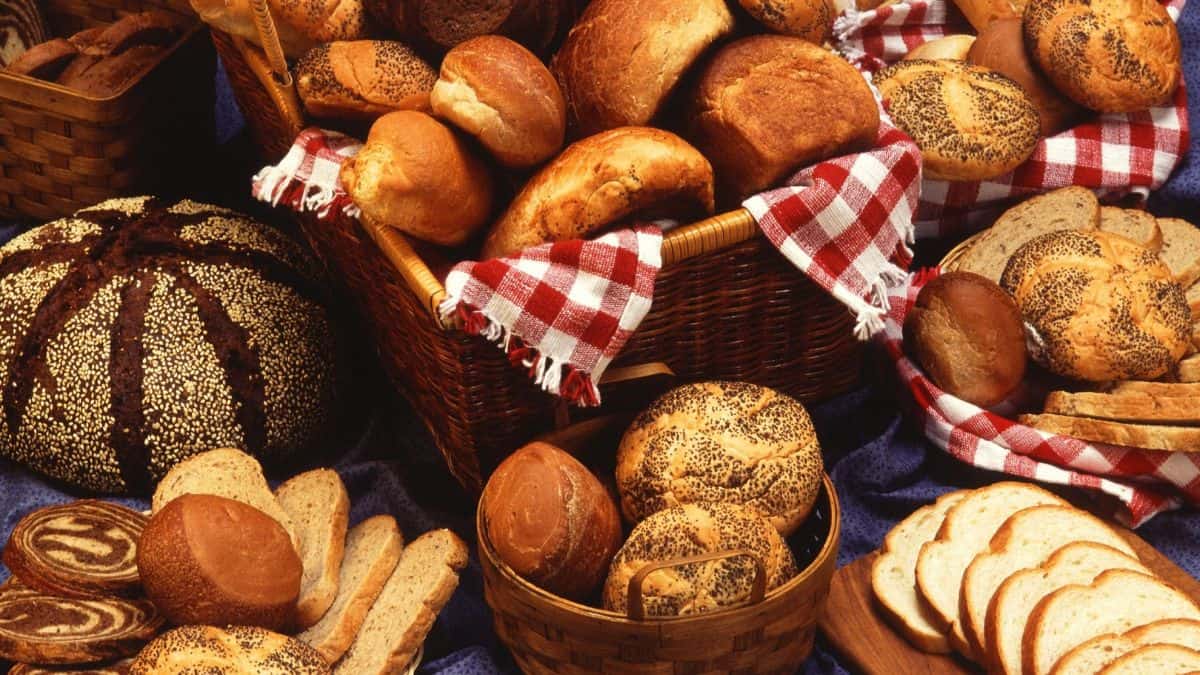 Assorted breads on a wooden board.