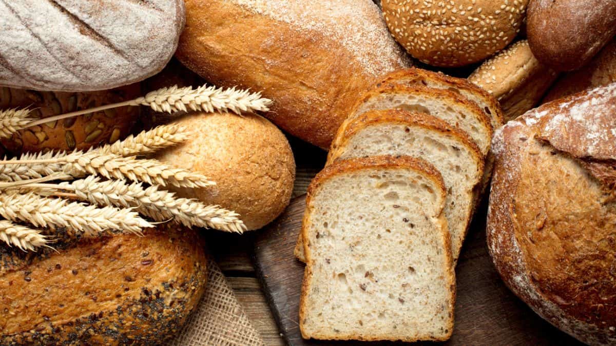 Different types of breads on a wooden board.