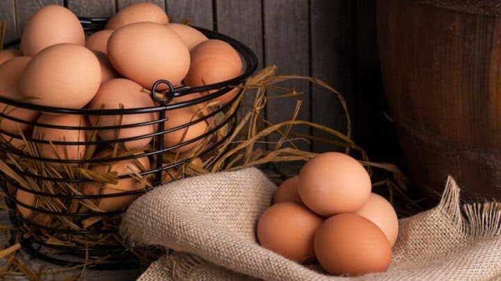 Eggs in a basket and on a cloth.