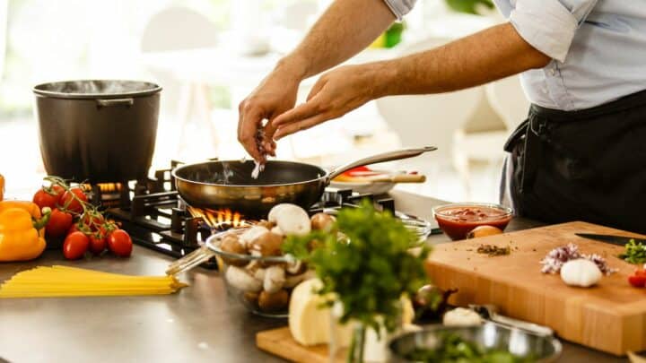 Image shows a person cookin.