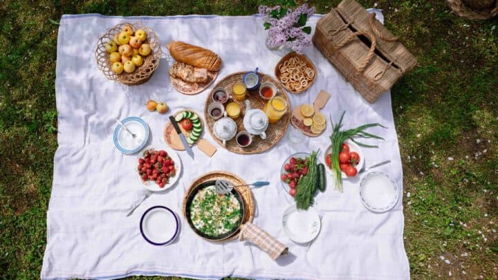 A blanket with picnic food.