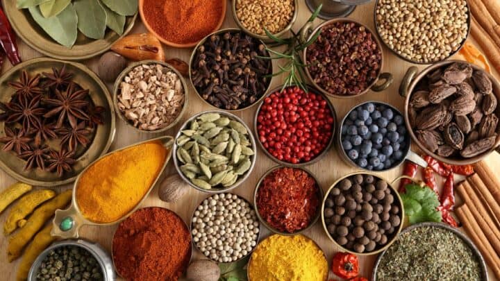 Various spices on a wooden board.