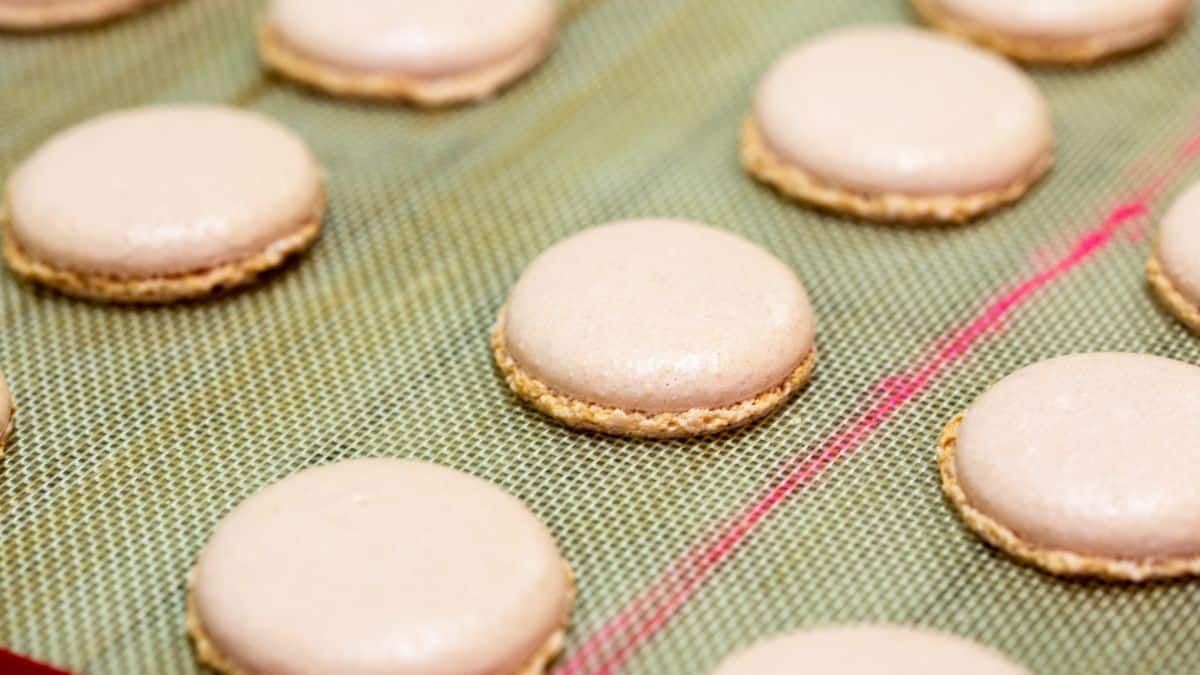 Macarons baked on a silicon baking mat.