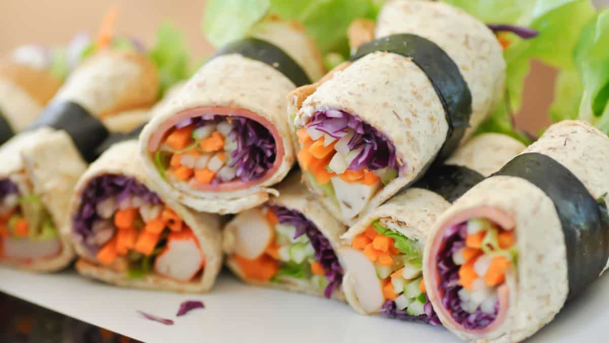 Veggie-stuffed bread rolls on a white plate.