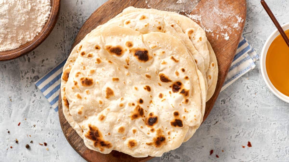 A stack of chapati on a board.