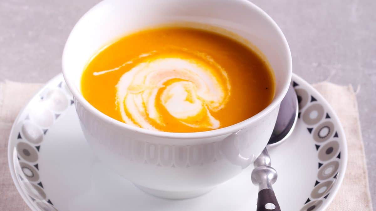 A bowl of soup garnished with yogurt.