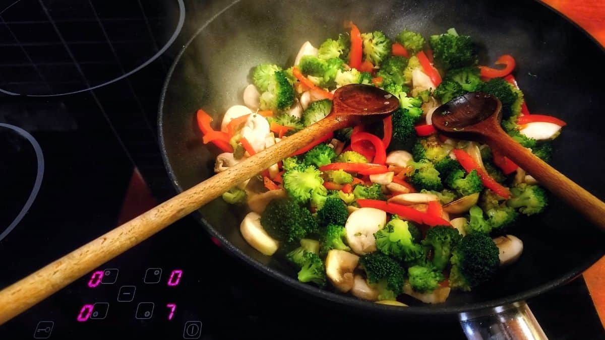 Vegetables stir fried in a wok.