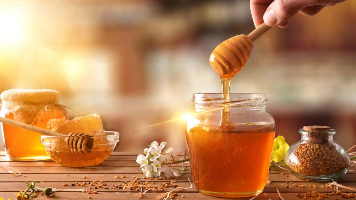 Honey in a jar with honey spoon.