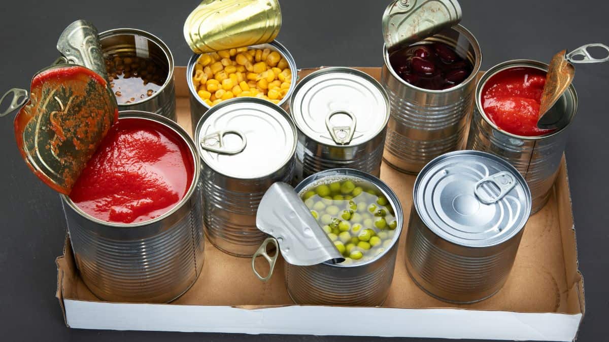 Canned foods on a wooden tray.