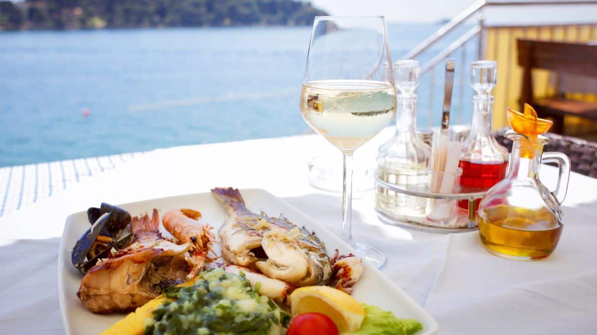 Seafood platter with a glass of white wine.