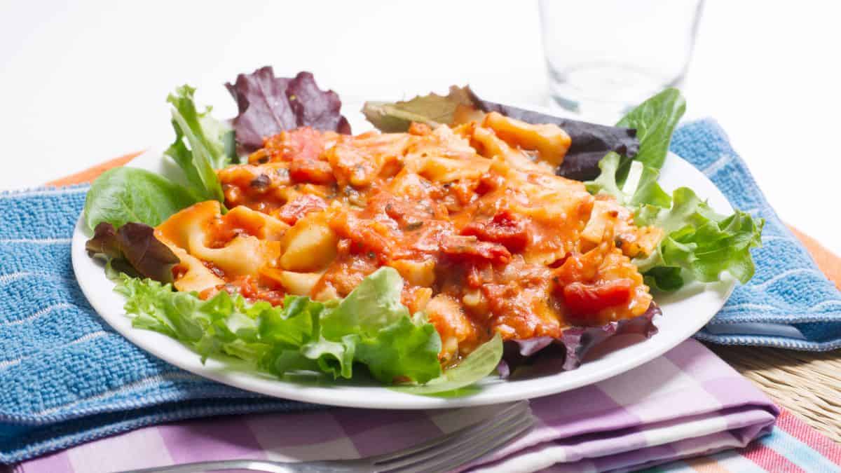 Romano pasta served with salad.