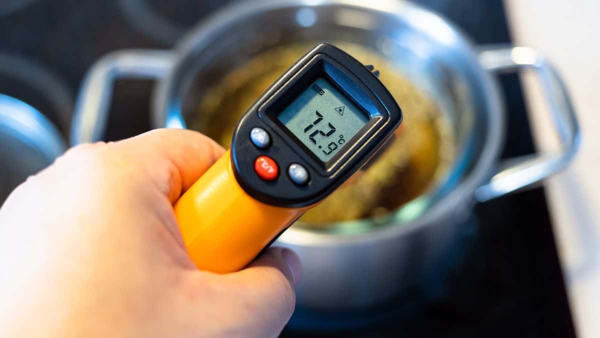 Person holding a digital thermometer.