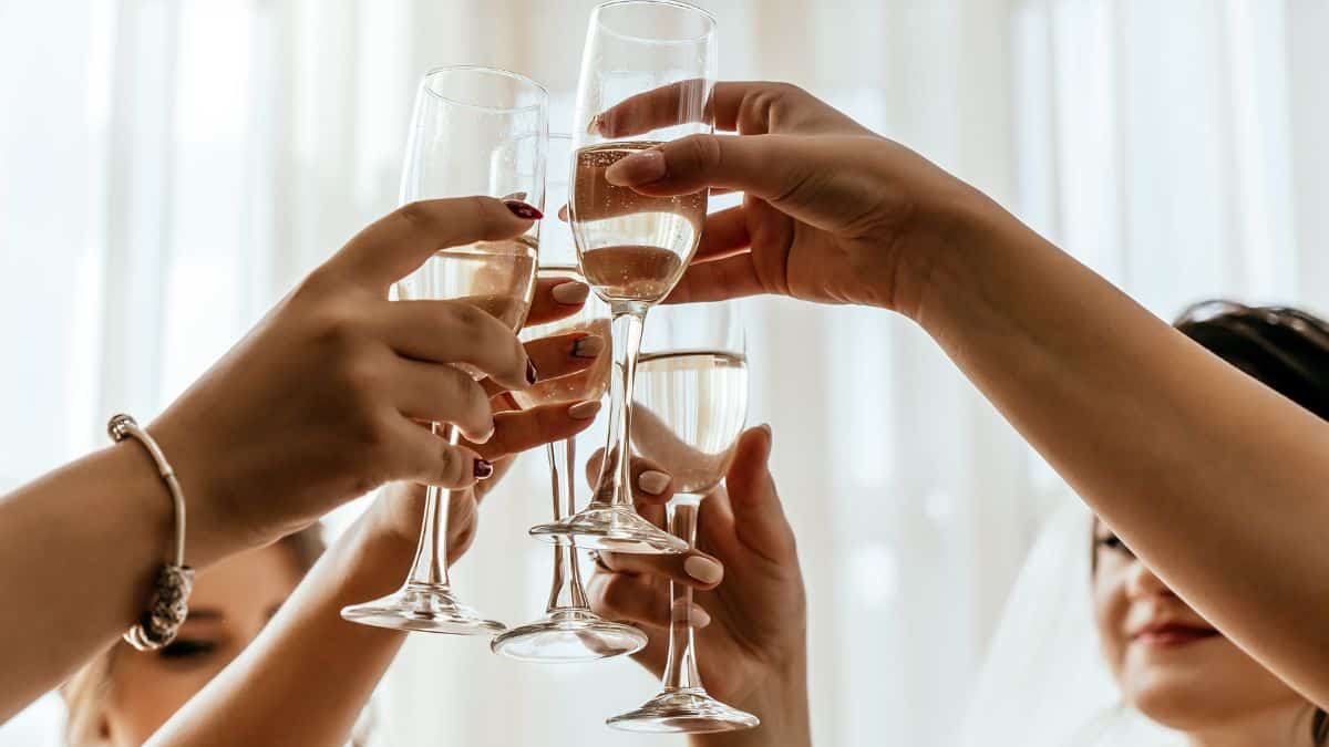 People cheering with a champagne glass.