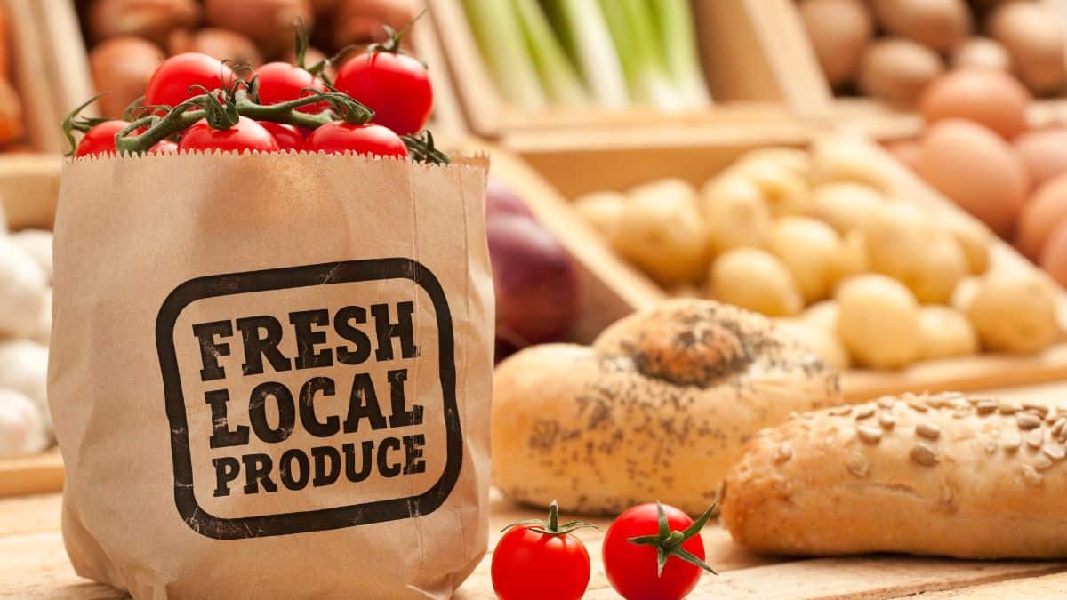 A bag of fresh local produce on a counter.