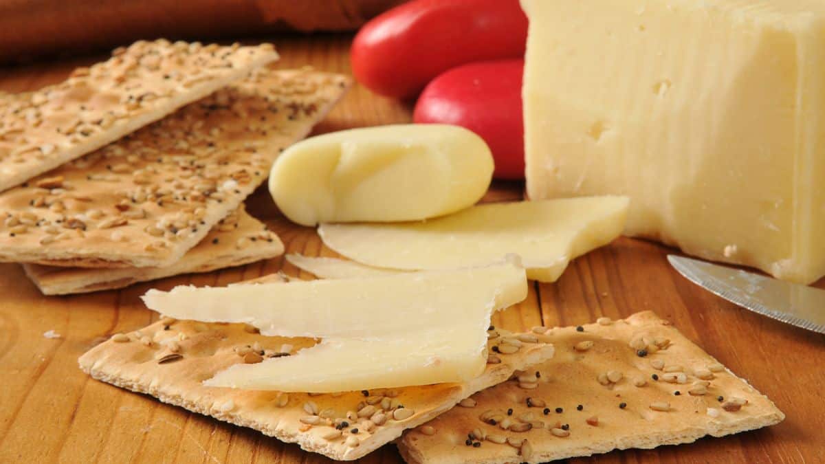 Pieces of asiago cheese on crackers.