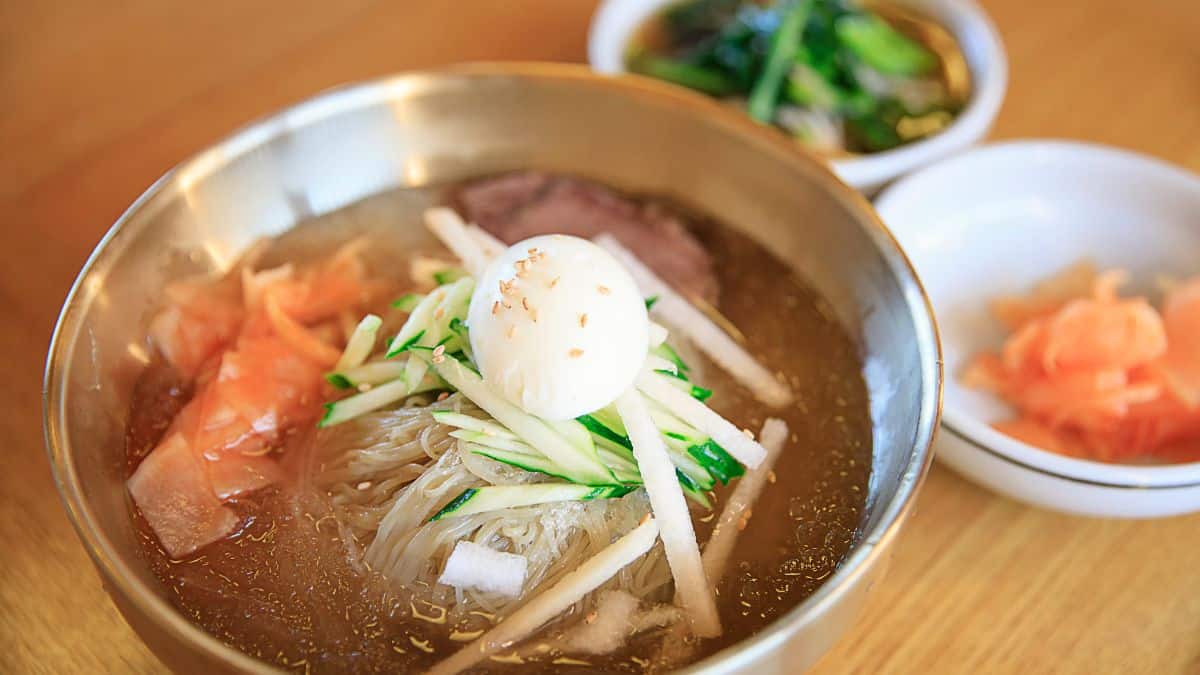 Naengmyeon in a brass bowl.