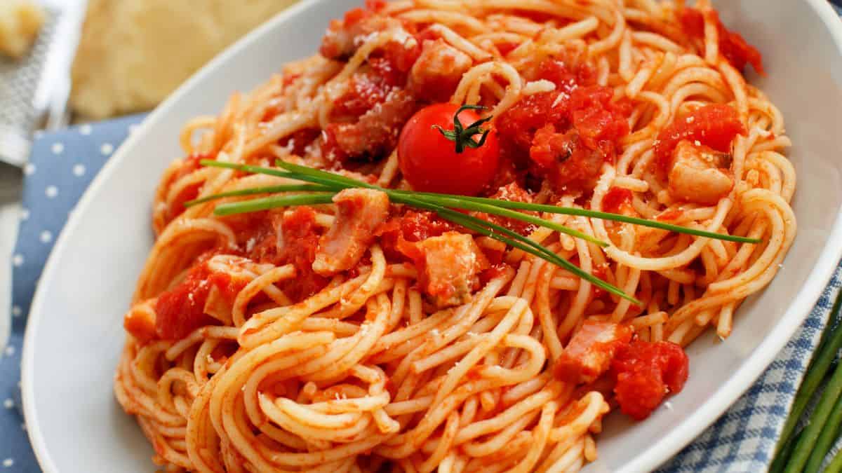 Amatriciana pasta topped with cherry tomatoes.