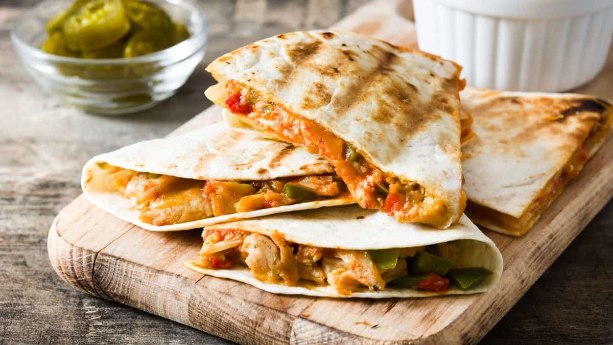 Quesadillas on a brown plate.