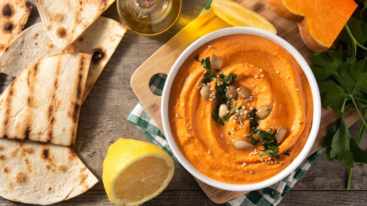 Pumpkin hummus served with pita bread.