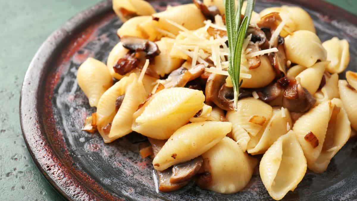 Conchiglie pasta on a rustic plate.