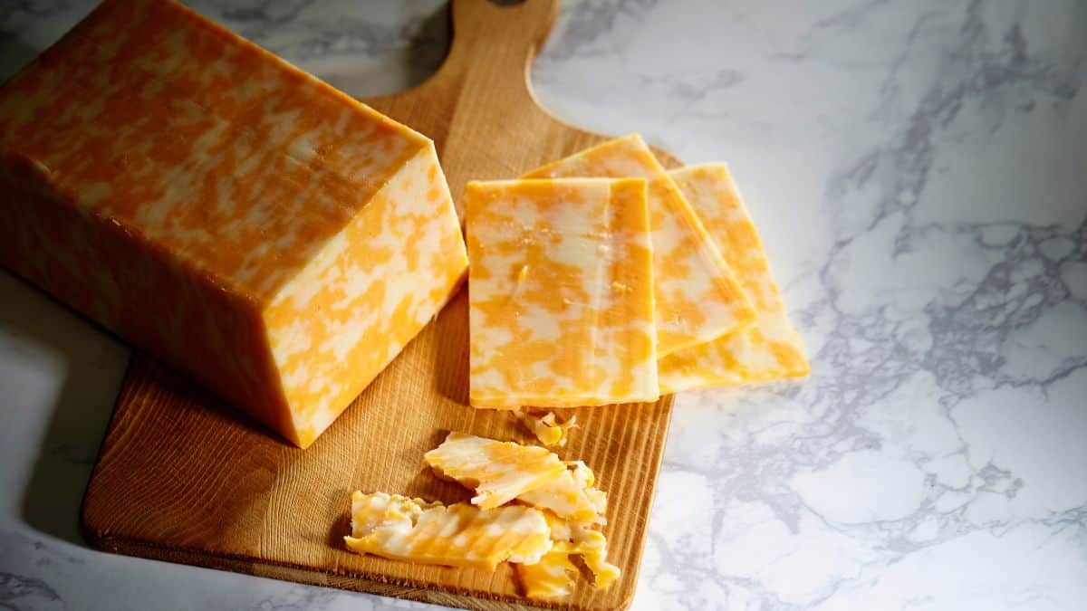 Block and cubes of colby cheese.