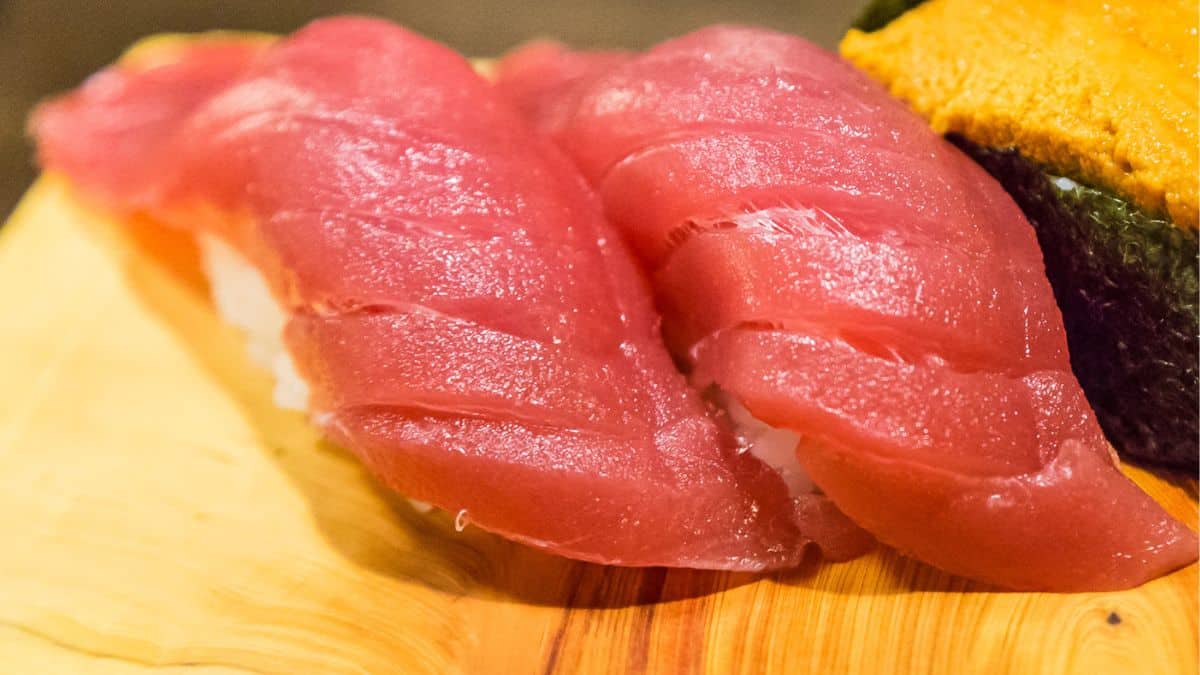 Toro nigiri on a wooden board.