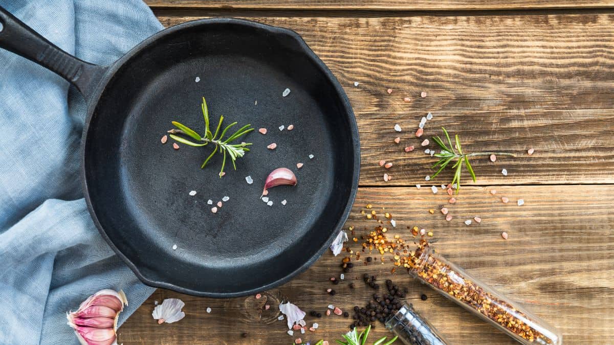 Seasoned cast iron skillet on a wooden surface.