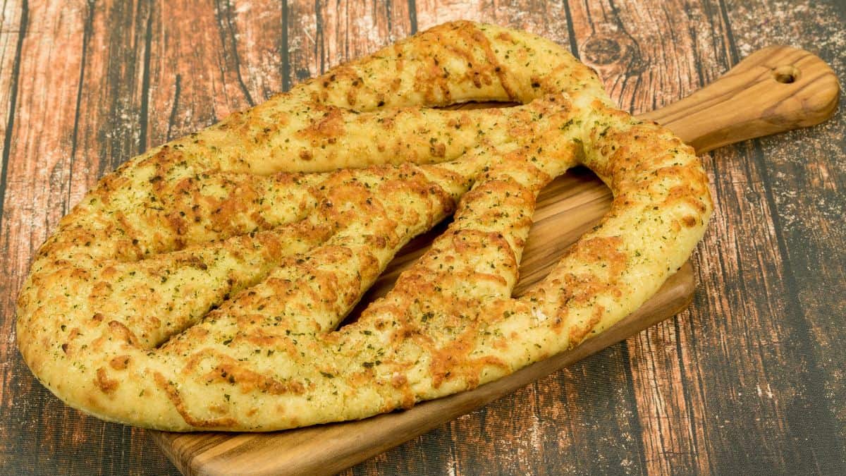 Fougasse bread on a wooden board.