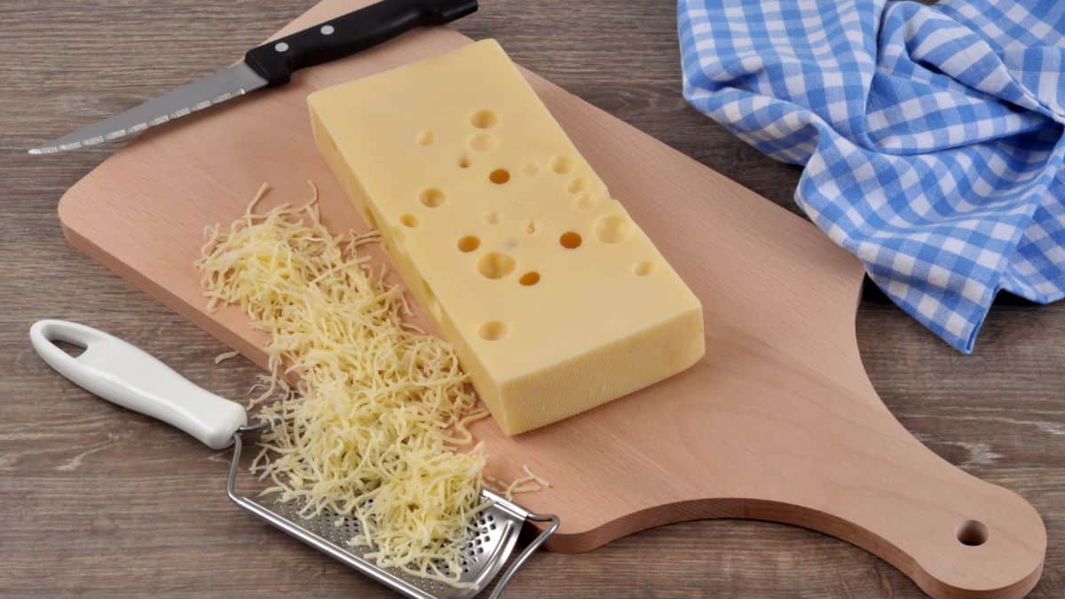 Gruyere cheese block and grated.