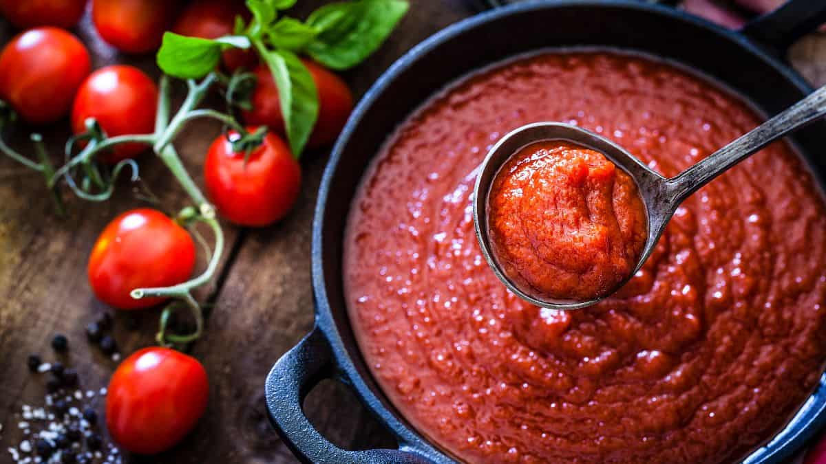 Tomato and basil sauce cooked in a big pot.