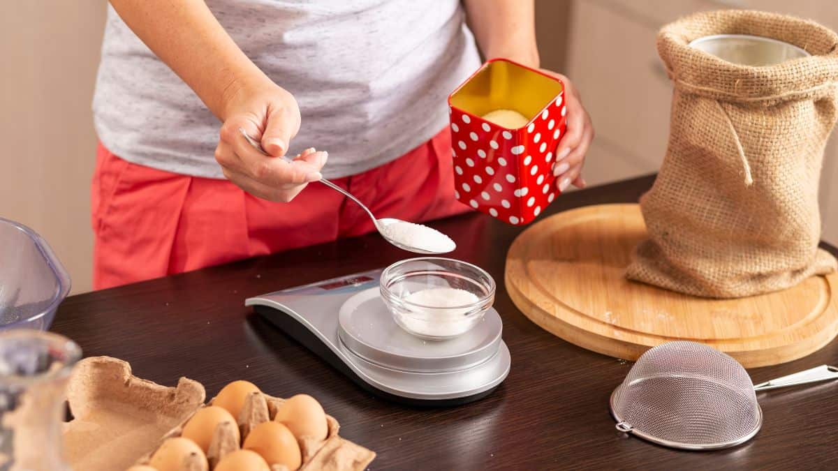 Person measuring flour.