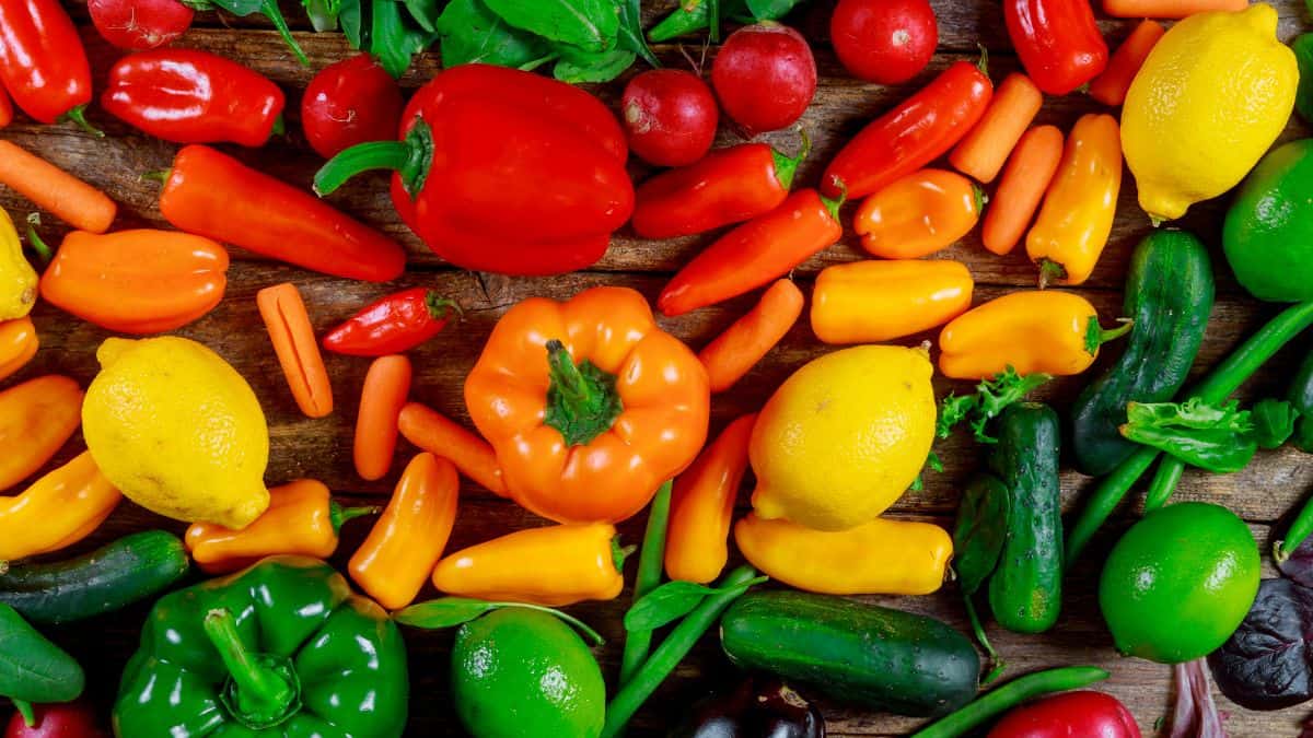 Colorful veggies on a wooden board.