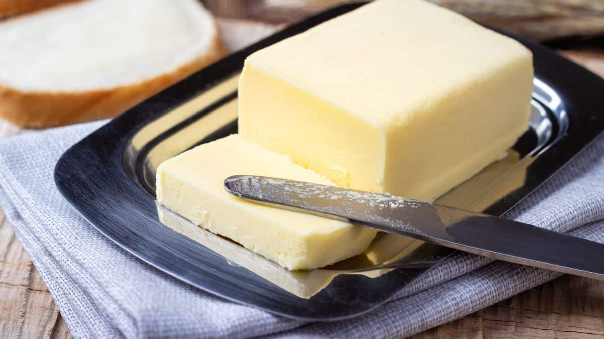 A block of soft butter on a countertop.