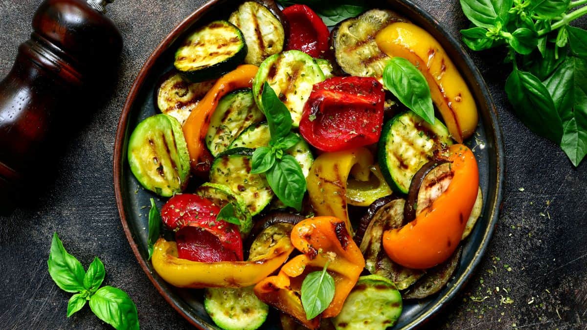 Grilled vegetables in a black plate.