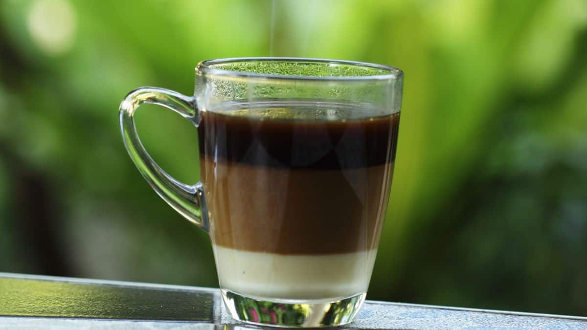 A cup of bombon coffee on a table.