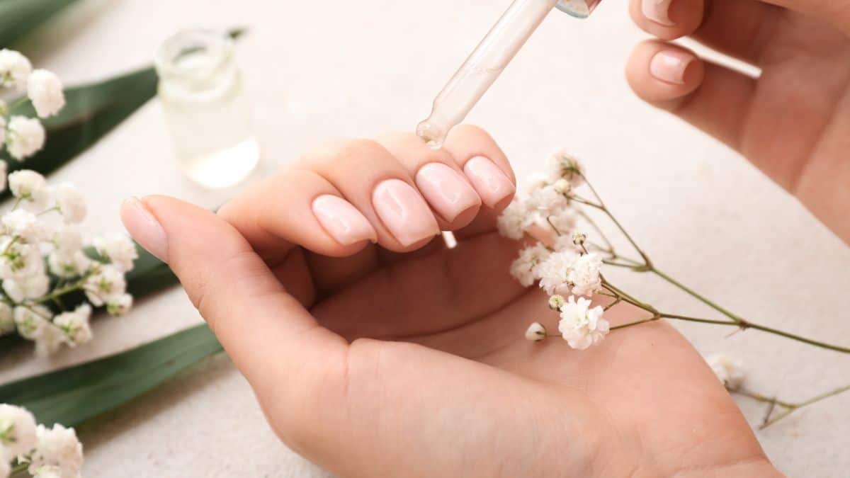 Woman applying cuticle oil.