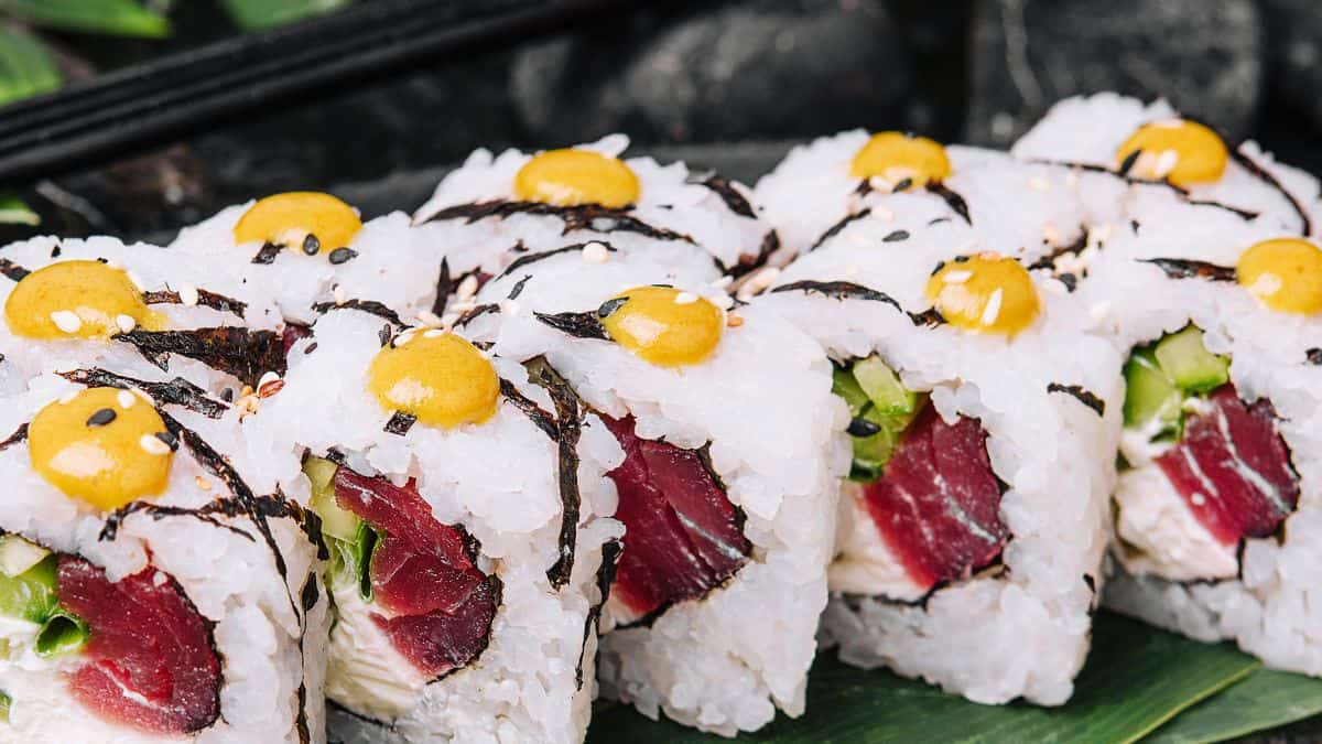 Close up of spicy tuna roll topped with wasabi.