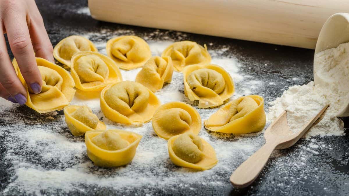 Woman making tortellini.