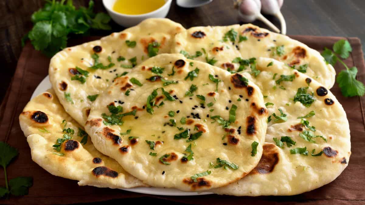 Naan bread topped with butter and cilantro.