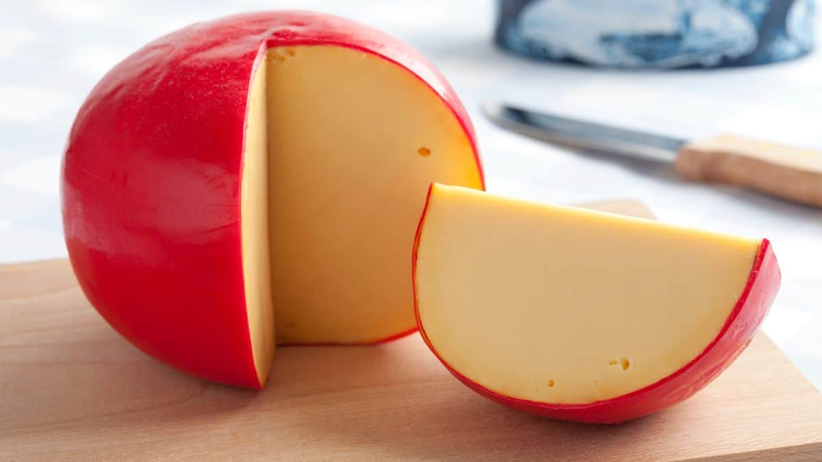 Edam cheese on a wooden board.