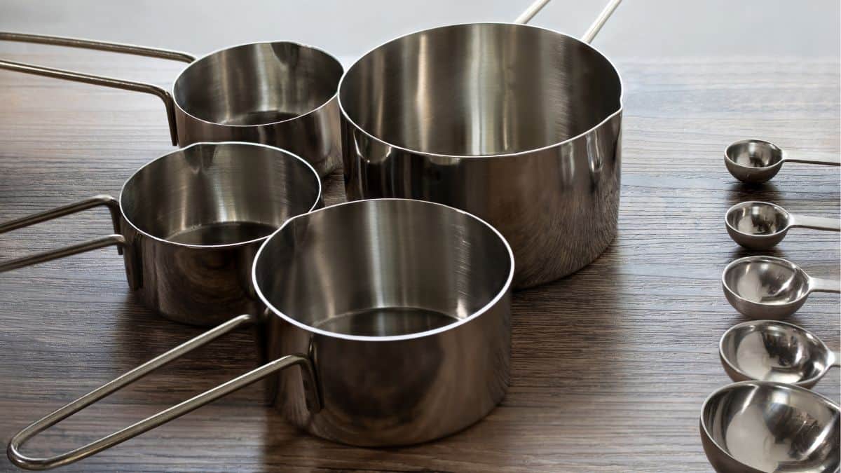 Measuring cups and spoons on a wooden board.