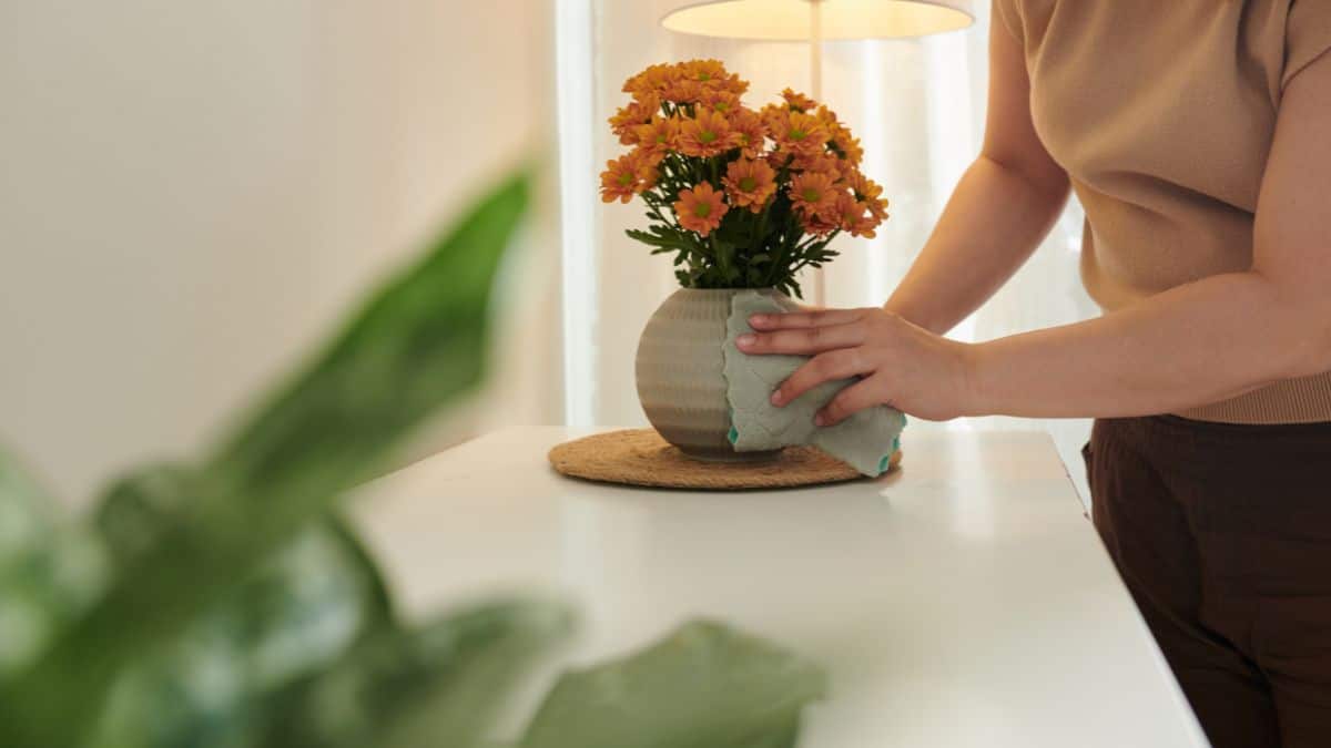 Woman cleaning a vase.