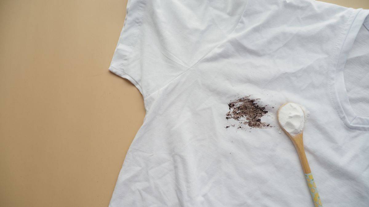 Stained cloth with baking soda spoon.