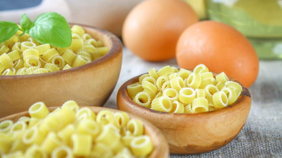 Ditalini pasta in brown bowls.