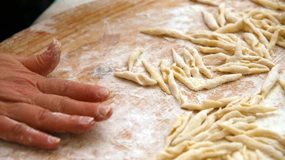 Person making strozzapreti pasta.