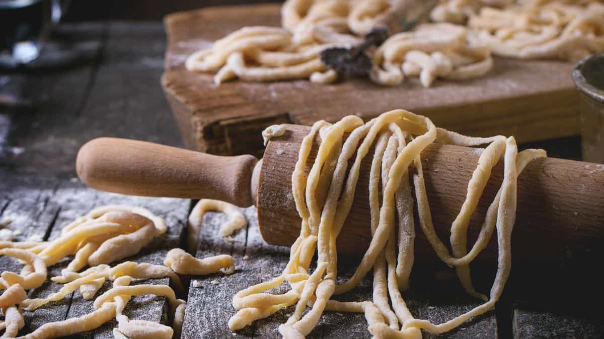 Pici pasta on a rolling pin.