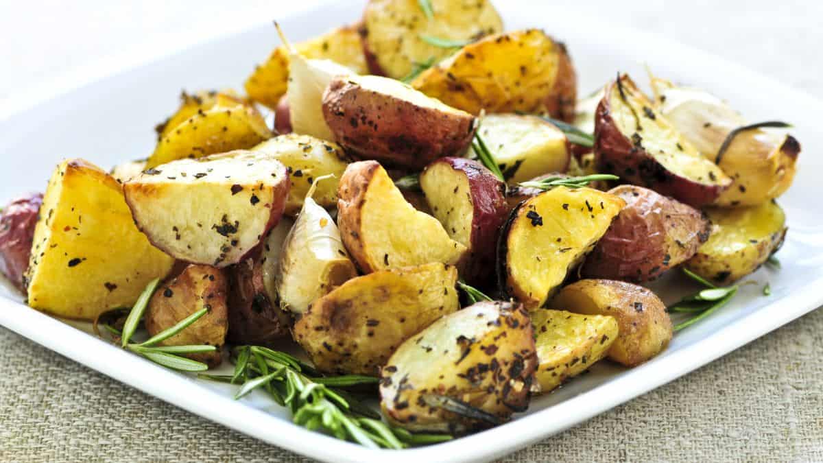 Roasted potatoes on a white plate.