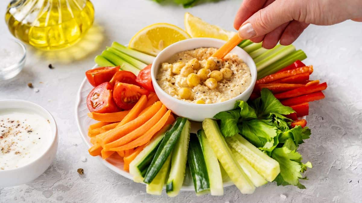 Hummus served with vegetable sticks.